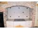 Kitchen cooktop with brick accent wall and granite countertop at 772 Bear Creek Cir, Winter Springs, FL 32708