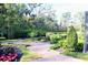 Expansive landscaped yard with lush greenery and brick pathways at 772 Bear Creek Cir, Winter Springs, FL 32708