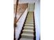 Elegant staircase with wooden railing and neutral carpeting at 772 Bear Creek Cir, Winter Springs, FL 32708