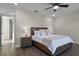 Spacious bedroom with wooden bed frame, nightstands and ceiling fan at 8135 Coconut Pl, Kissimmee, FL 34747