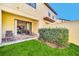 Landscaped backyard with grassy area and patio at 8169 Roseville Rd, Davenport, FL 33896