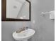 Modern bathroom with pedestal sink, granite vanity, and updated fixtures at 8169 Roseville Rd, Davenport, FL 33896