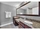Double vanity bathroom with granite countertops and large mirror at 8169 Roseville Rd, Davenport, FL 33896