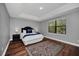 Spacious bedroom with hardwood floors and a large window at 8169 Roseville Rd, Davenport, FL 33896