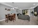 Bright dining area with wood table and chairs, adjacent to living room at 8169 Roseville Rd, Davenport, FL 33896