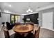 Wood dining table with four chairs in open concept living space at 8169 Roseville Rd, Davenport, FL 33896