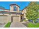 Tan two-story townhome with two-car garage and landscaping at 8169 Roseville Rd, Davenport, FL 33896