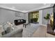 Living area with grey sofas, patterned rug, and patio access at 8169 Roseville Rd, Davenport, FL 33896