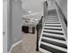 Modern staircase with dark wood and white risers at 8169 Roseville Rd, Davenport, FL 33896