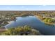 Aerial view showing a house near a lake and residential area at 117 Blue Heron Ct, Davenport, FL 33837