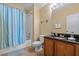 Clean bathroom with a shower/tub combo and wood vanity at 117 Blue Heron Ct, Davenport, FL 33837
