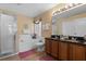 Double vanity bathroom with soaking tub, shower and granite countertop at 117 Blue Heron Ct, Davenport, FL 33837