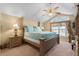Spacious bedroom with large window and ceiling fan at 117 Blue Heron Ct, Davenport, FL 33837
