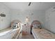 Two twin beds, nightstand, and butterfly wall decals in a bright bedroom at 117 Blue Heron Ct, Davenport, FL 33837