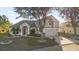 Two-story house with gray siding, red door, and attached garage at 117 Blue Heron Ct, Davenport, FL 33837