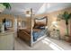 Elegant main bedroom with a post bed, ample space and ensuite bathroom at 117 Blue Heron Ct, Davenport, FL 33837