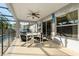 Covered patio with table and chairs, adjacent to the pool at 117 Blue Heron Ct, Davenport, FL 33837