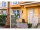 Front view of a yellow townhouse with a white fence and gate at 1330 Bolton N Pl, Lake Mary, FL 32746