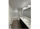 Bathroom with double vanity, tub, and tile flooring at 247 Villavista Ct, Davenport, FL 33896