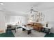 Bright and airy living room featuring a brown leather sofa and large windows at 3 Maple Run, Haines City, FL 33844
