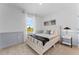 Bright bedroom with a queen-size bed, neutral decor, and a large window at 3313 Private Oak Dr, Apopka, FL 32703
