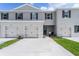 Modern two-story townhome with attached garage and landscaped front yard at 3313 Private Oak Dr, Apopka, FL 32703