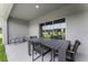 Covered patio with outdoor dining set and view of green space at 3313 Private Oak Dr, Apopka, FL 32703