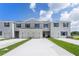 Three-unit townhome building with attached garages and landscaping at 3319 Private Oak Dr, Apopka, FL 32703