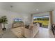 Spacious living room with large windows, neutral decor, and a view of the backyard at 3319 Private Oak Dr, Apopka, FL 32703