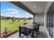 Covered patio with outdoor dining set, offering a relaxing view of the surrounding landscape at 3325 Private Oak Dr, Apopka, FL 32703