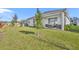 Landscaped backyard with covered patio and lush grass at 4473 Davos Dr, Clermont, FL 34711