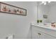 Clean and modern powder room with white vanity and quartz countertop at 4473 Davos Dr, Clermont, FL 34711