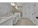 Spa-like bathroom with dual vanities, quartz countertops, and a large walk-in shower at 4473 Davos Dr, Clermont, FL 34711