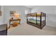 Bedroom with a bunk bed, desk, and neutral decor at 4473 Davos Dr, Clermont, FL 34711