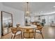 Open concept dining room features a round table with seating for four, adjacent to a modern kitchen at 4473 Davos Dr, Clermont, FL 34711