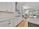 Modern kitchen with white cabinets, stainless steel appliances and a large island at 4473 Davos Dr, Clermont, FL 34711