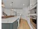 Modern kitchen with a large island, white cabinets, and quartz countertops at 4473 Davos Dr, Clermont, FL 34711