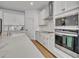 Modern kitchen with white cabinets, stainless steel appliances, and quartz countertops at 4473 Davos Dr, Clermont, FL 34711
