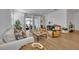 Living room with hardwood floors, comfortable seating and large windows at 4473 Davos Dr, Clermont, FL 34711