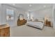 Spacious main bedroom with a king-size bed, dresser, and ample natural light at 4473 Davos Dr, Clermont, FL 34711
