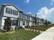 Two-story townhomes with gray siding and landscaping at 576 Pothos St, Apopka, FL 32703