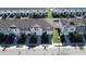 Aerial view of townhomes showcasing community layout and solar panels at 604 Madison Dr, Davenport, FL 33837