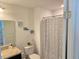 Clean bathroom with a shower/tub combo and patterned curtain at 604 Madison Dr, Davenport, FL 33837