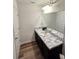 Clean bathroom, featuring a vanity with marble top at 604 Madison Dr, Davenport, FL 33837