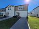 Two-story townhome with two-car garage and landscaped front yard at 604 Madison Dr, Davenport, FL 33837
