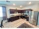 Modern kitchen with dark cabinets and granite countertops at 604 Madison Dr, Davenport, FL 33837