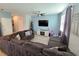 Spacious living room featuring a large sectional sofa and flat-screen TV at 604 Madison Dr, Davenport, FL 33837