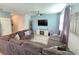 Living room with sectional sofa and a large TV at 604 Madison Dr, Davenport, FL 33837