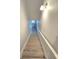 Modern staircase with light wood risers and white railing at 604 Madison Dr, Davenport, FL 33837