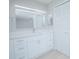 Bathroom with white vanity, modern mirror, and louvered doors at 620 Cranes Way # 207, Altamonte Springs, FL 32701
